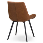Rear three-quarter view of the tan dining chair, with a central seam down the mottled back, curved side profile and black splayed legs.