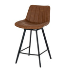 Three-quarter view of the tan bar stool showing its curved channel-stitched shell, black splayed legs and connecting footrest rails.