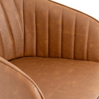 Close-up of the chair's tan interior showing vertical stitched channels, fine grain-like surface texture and the plain seat below.