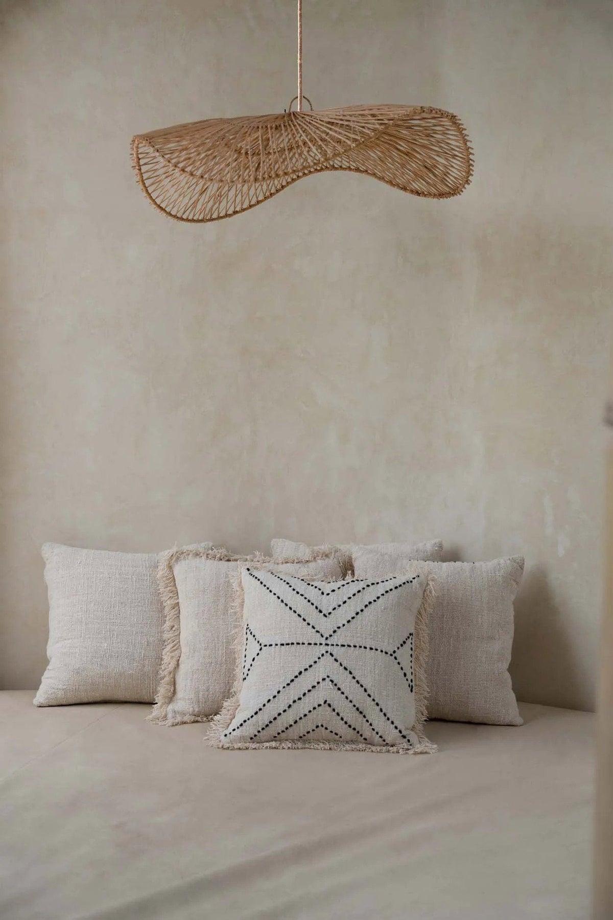 Chapeau Rattan Pendant Light – Natural, Large – styled above a bed