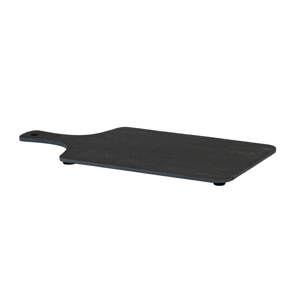 Low angled view of the charcoal serving board showing its thin edge, rounded corners and black pads beneath.
