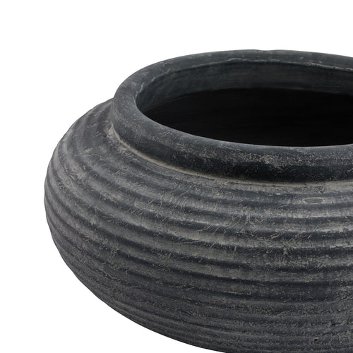 Angled close-up of the planter's rounded rim and dark interior, with pale mottling across the charcoal-grey ribs below.