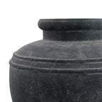Close-up of the charcoal planter's twin raised shoulder bands and irregular pale marks across its curved surface.