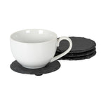 White cup resting on a charcoal round coaster, with the other rough-edged coasters stacked behind it on a white background.
