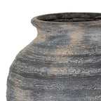 Detail of the vase's flared lip and curved shoulder, with taupe-brown patches across the charcoal finish and dense horizontal scoring.
