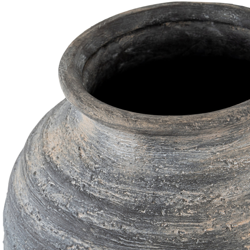 Close view looking into the vase's dark opening, showing its thick rolled rim and the scored, pitted surface around the neck.
