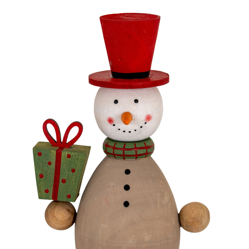 Close-up of the snowman's rosy cheeks, dotted smile, red top hat and checked green collar beside a spotted present with a looped red bow.