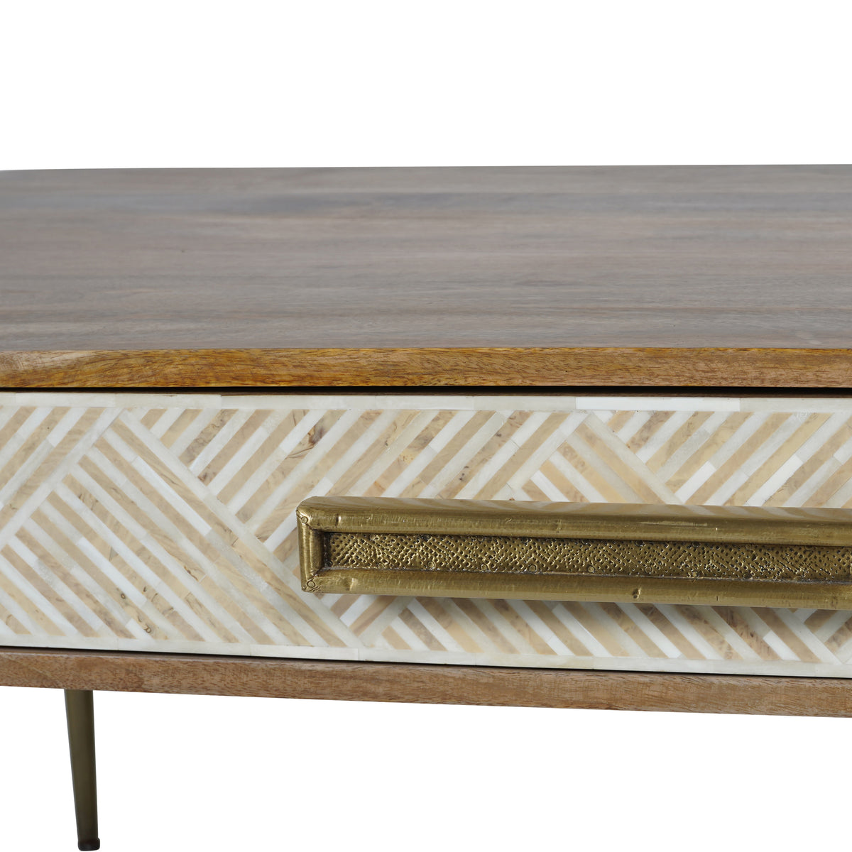 Close-up of the ivory chevron inlay and aged gold drawer handle with its textured inset, beneath the wood top.