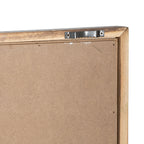 Rear corner of the plaque showing a brown backing, angled frame corner and a silver-coloured toothed bracket secured by two screws.