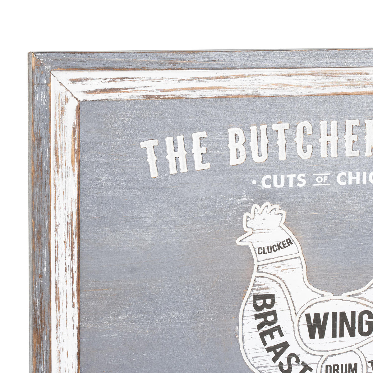Close-up of the plaque's upper left corner, showing the distressed grey and white border, cropped butcher's-guide lettering and the chicken's Clucker label.