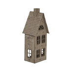Angled view of the house-shaped candle holder showing the ridged roof, chimney, front windows and single side window.