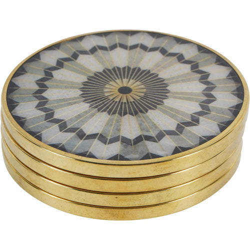 Four round coasters stacked, showing gold-toned edges and a black, grey and ivory sunburst face.