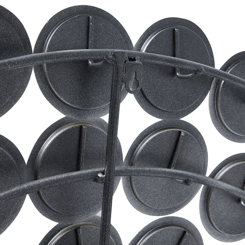 Close-up of the mirror's rear, showing dark circular backs, curved support bars and a keyhole-shaped hanging fitting.