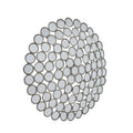 Angled view of the circular mosaic wall mirror, showing small round mirrors with antiqued silver-coloured rims and spaces between them.