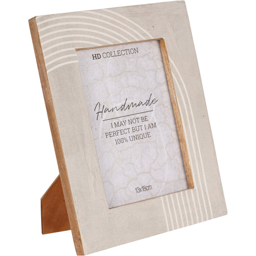 Angled view of a cream photo frame with white corner arcs, exposed brown wood edges and a rear easel supporting portrait display.