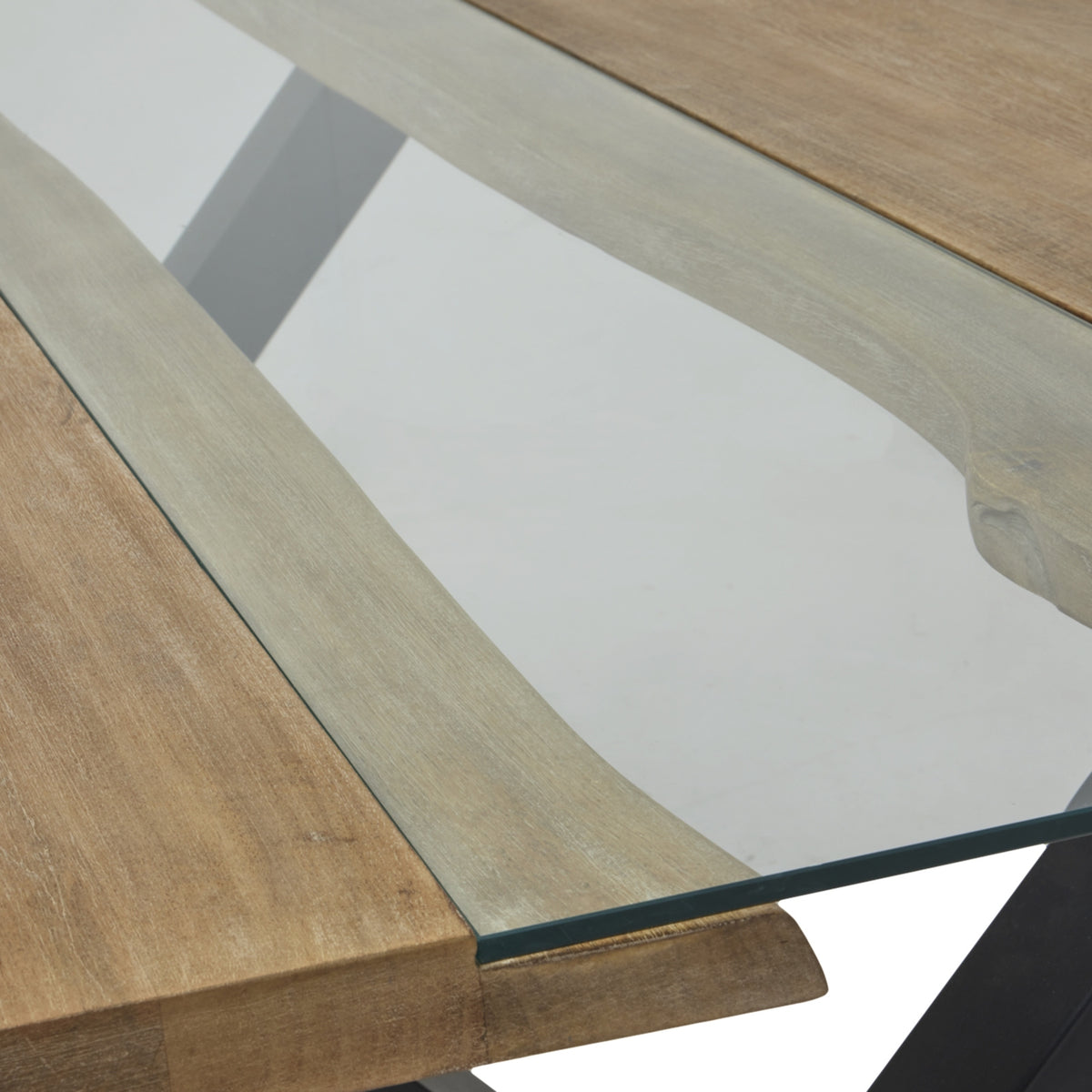 Detail of the transparent central panel with irregular grain-patterned edges visible beneath it and a dark edge across the end of the tabletop.
