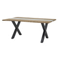 Clear Channel Dining Table viewed at an angle, with pale outer tabletop sections, a transparent centre and two black X-shaped supports.