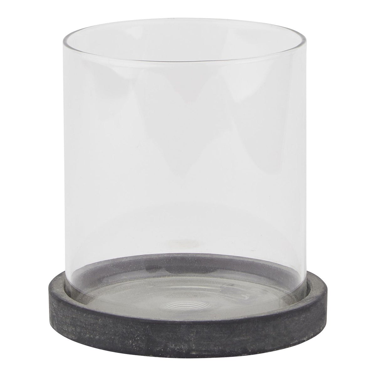 Front view of a clear cylindrical candle lantern on a shallow, mottled dark grey circular base against white.