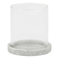 Front view of a clear cylindrical candle lantern with a shallow pale grey round base and mottled finish.