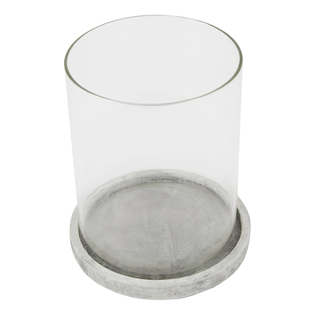 Candle lantern viewed from above at an angle, showing the open circular top, clear sides and grey markings across the round base.