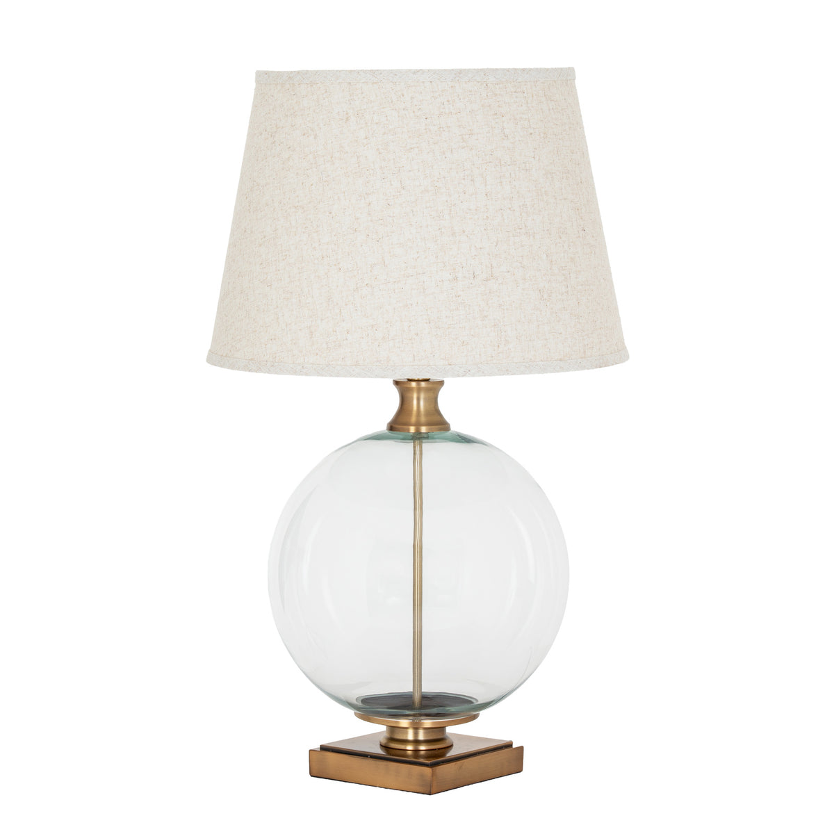 Clear Spherebody Table Lamp on a white background, with a pale tapered shade, transparent round body and brass-toned square base.