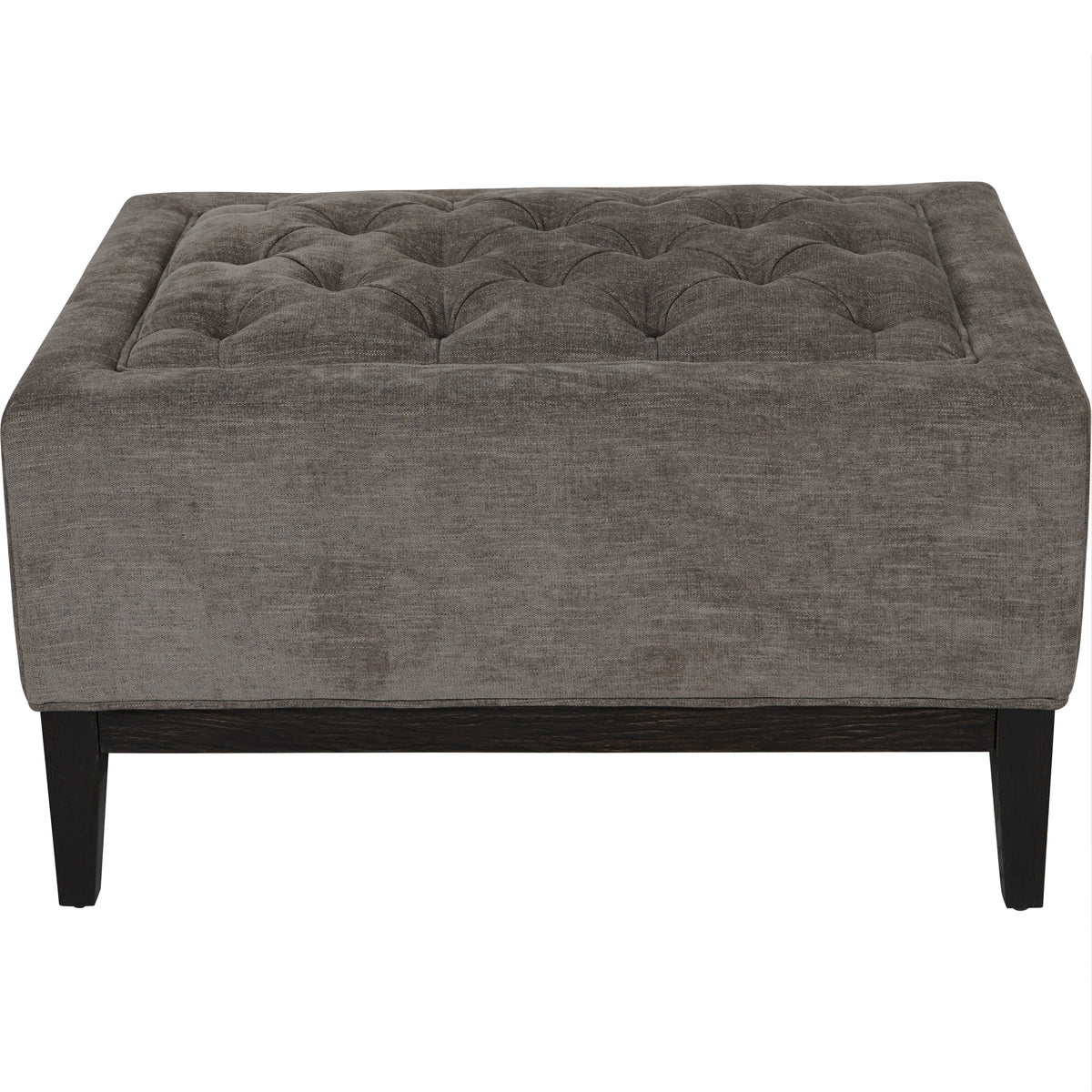 Front view of the warm grey Clubroom footstool showing its buttoned inset top and deep brown wooden base.