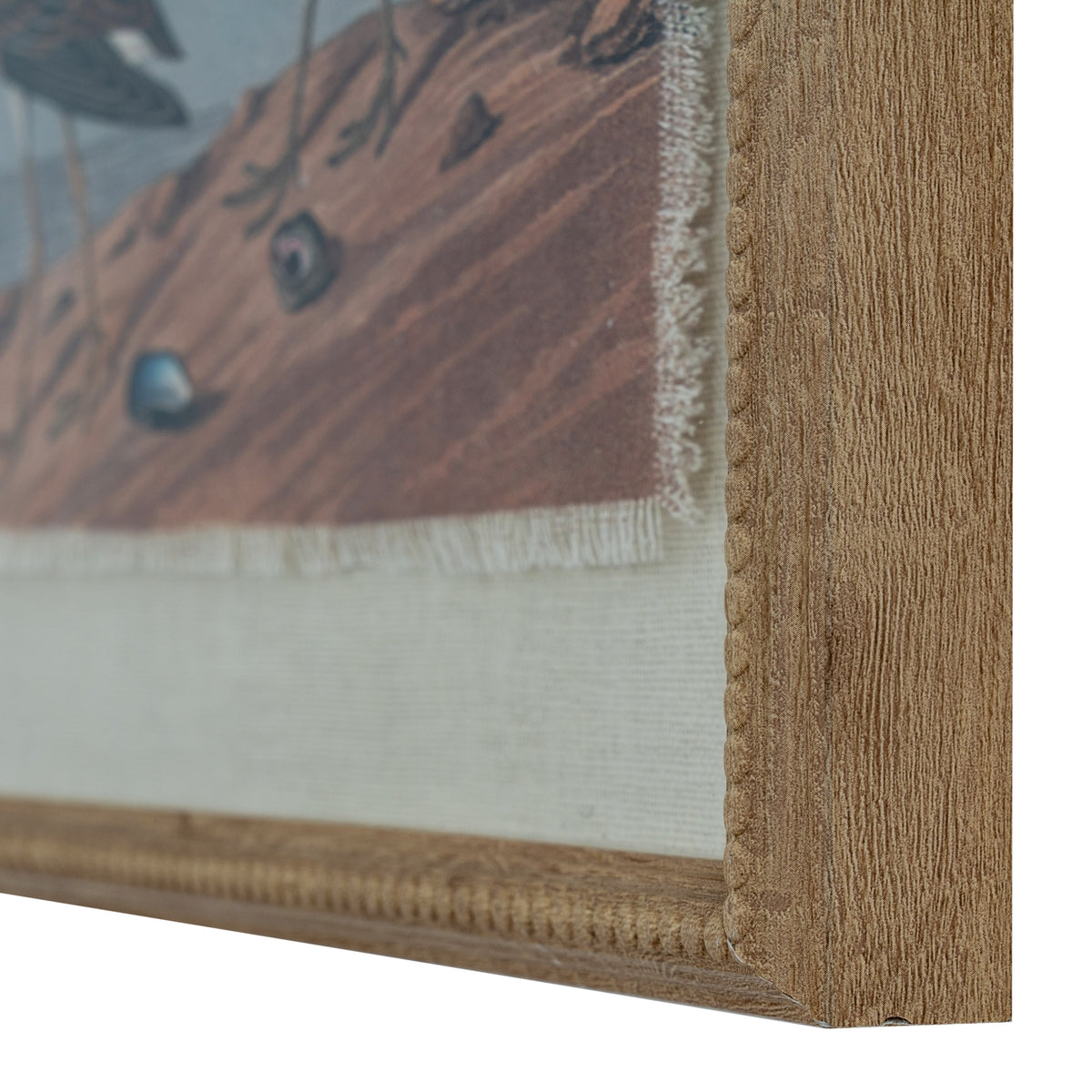 Angled close-up of the lower-right corner, showing the brown beach print, its frayed-looking edge, pale textured surround and beaded frame.