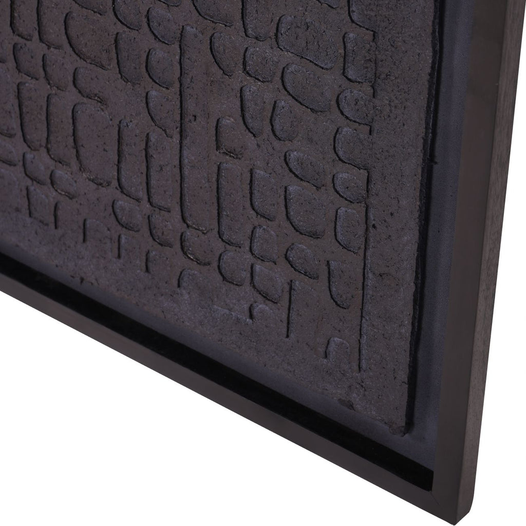 Angled close-up of the lower corner showing the dark cobbled relief, black backing border and frame.