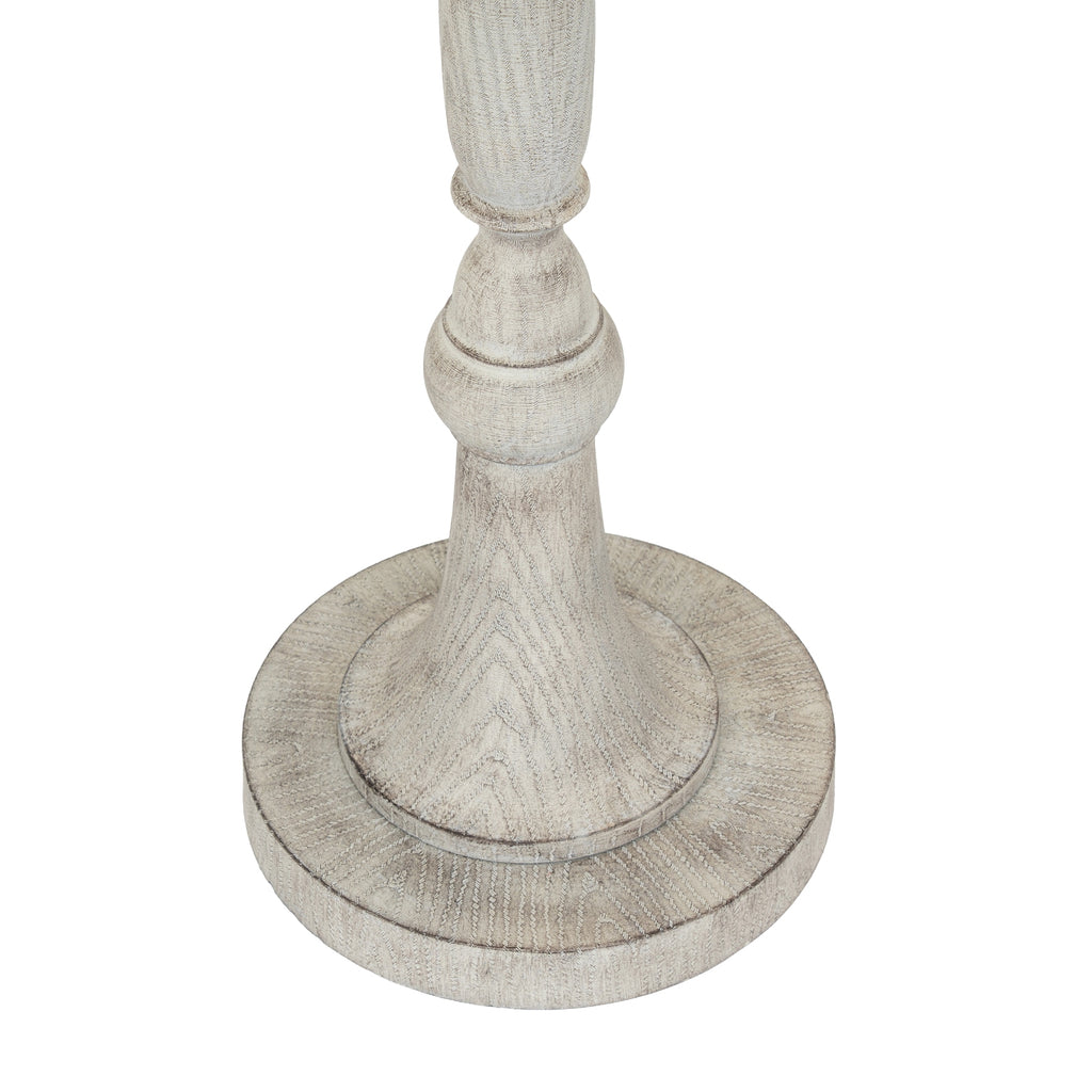 Close-up of the lamp's shaped lower stem and circular stepped foot, showing a pale grain-like pattern and darker contour lines.