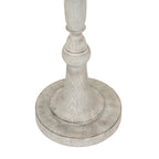 Close-up of the lamp's shaped lower stem and circular stepped foot, showing a pale grain-like pattern and darker contour lines.