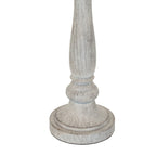 Close-up of the lamp's lower stem and broad circular foot, showing curved collar details and fine darker markings through the pale finish.