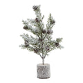 Full view of a miniature green tree with brown cone shapes, snowy white branches and a cylindrical bark-textured base.