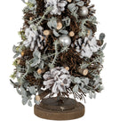 Close-up of the lower tree showing white-frosted pinecones, cut twig ends, pale green-grey sprigs and silver-toned spheres above the layered base.