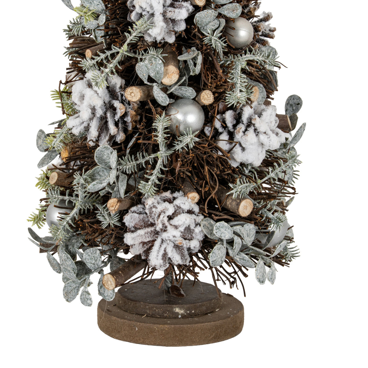 Close-up of the lower tree showing white-frosted pinecones, cut twig ends, pale green-grey sprigs and silver-toned spheres above the layered base.