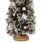 Close-up of the lower tree showing white-frosted pinecones, silver-toned spheres, pale leafy sprigs and cut twig ends above the layered brown base.