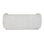Rear view of the pale cream sofa, showing its broad curved back, rounded ends and finely flecked surface.