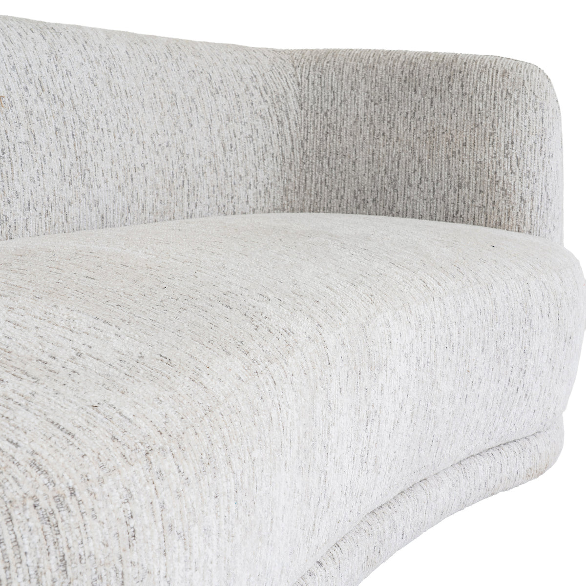 Close-up of the sofa's seat cushion and curved back, showing narrow lines and darker flecks in the pale cream surface.