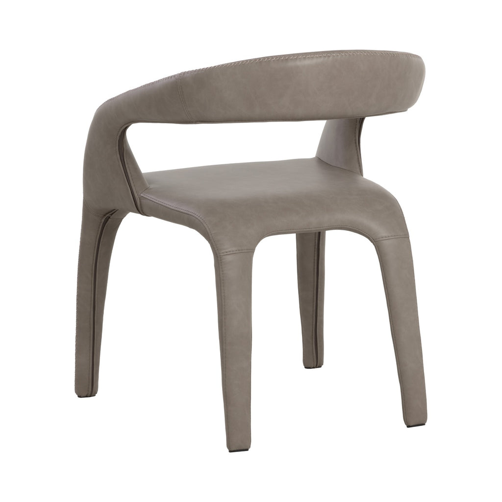 Rear three-quarter view of the taupe dining armchair with its curved upholstered back, large opening and continuous upholstery over the legs.
