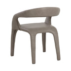Rear three-quarter view of the taupe dining armchair with its curved upholstered back, large opening and continuous upholstery over the legs.