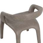 Close rear view of the taupe chair, showing cross-stitching along the curved back and arms, tonal variation in the faux leather and the seat below.