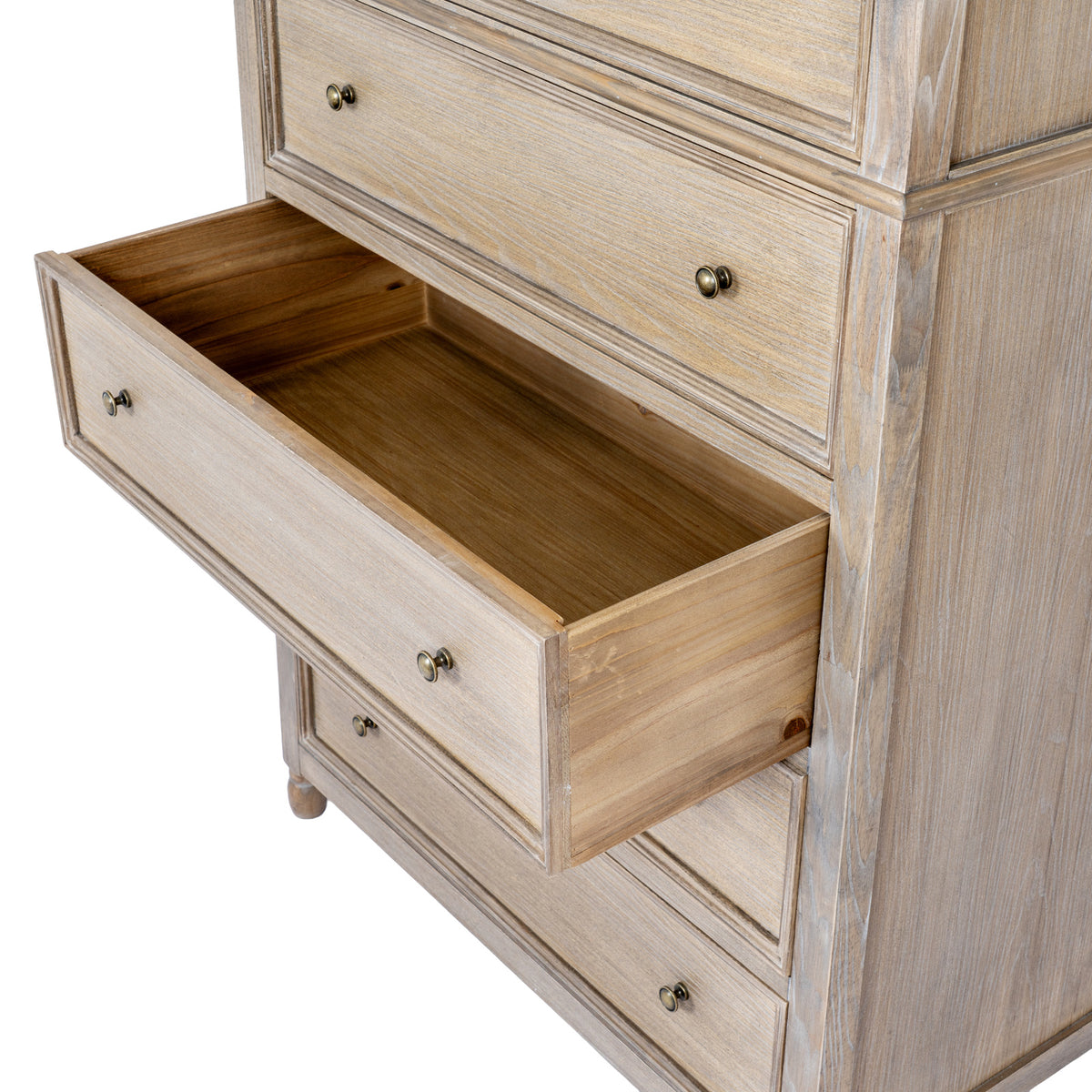 Angled detail of an open lower drawer, showing its empty interior, paired knobs and the framed closed drawers around it.
