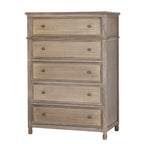 Three-quarter view of a tall tan-grey chest with five framed drawer fronts, paired brass-coloured knobs and short rounded feet.