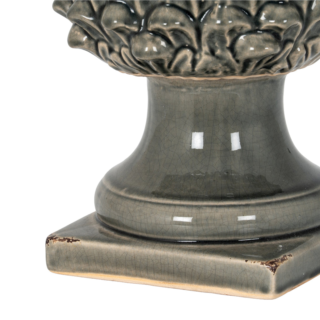 Detail of the ornament’s flared neck and square foot, showing fine crackle lines and distressed brown marks at the corners.