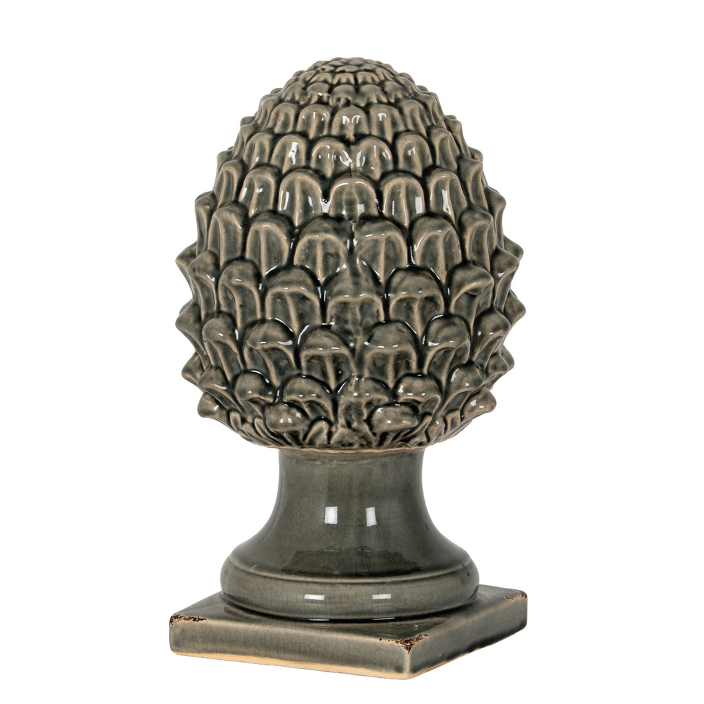 Dark grey acorn ornament with an oval scale-covered crown, flared pedestal and square foot against a white background.