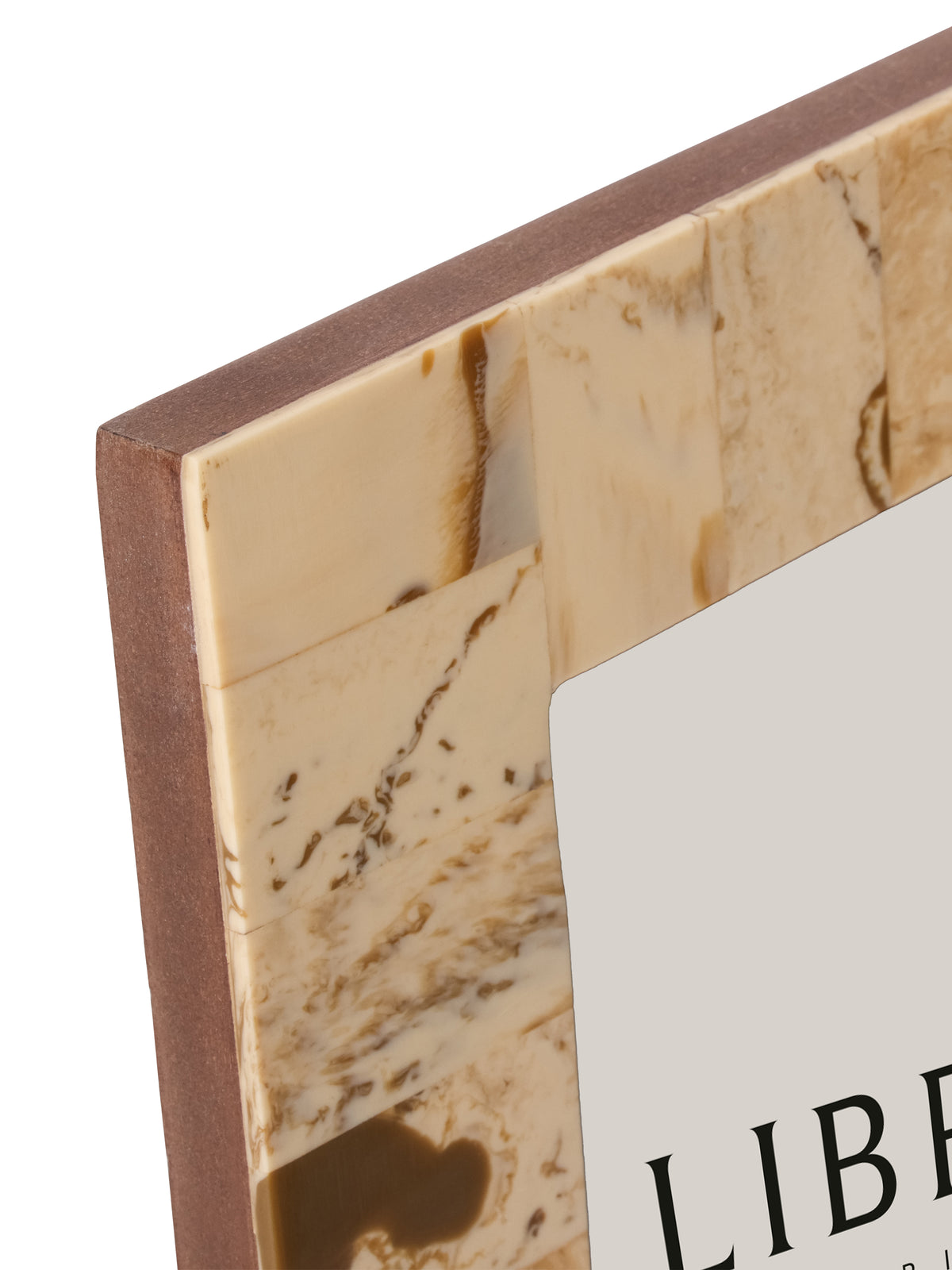Close-up of the frame's upper left corner showing the joined cream resin patches, brown markings and exposed brown side edge.