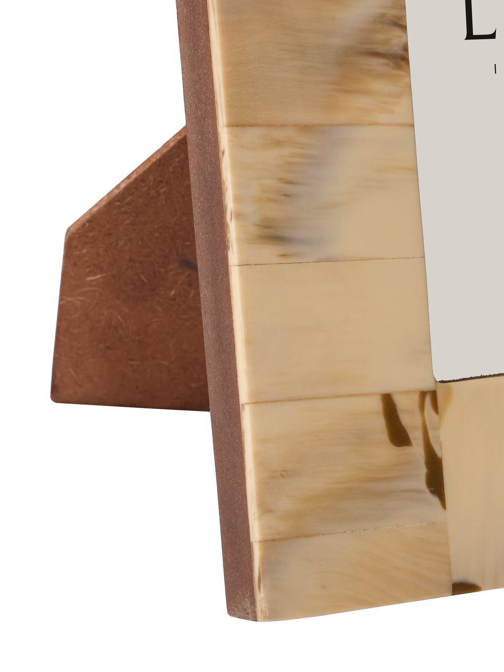 Close-up of the frame's lower left border with pale streaked resin sections and the brown easel support behind.