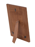 Brown back of the photo frame with an extended easel stand and three black retaining tabs.