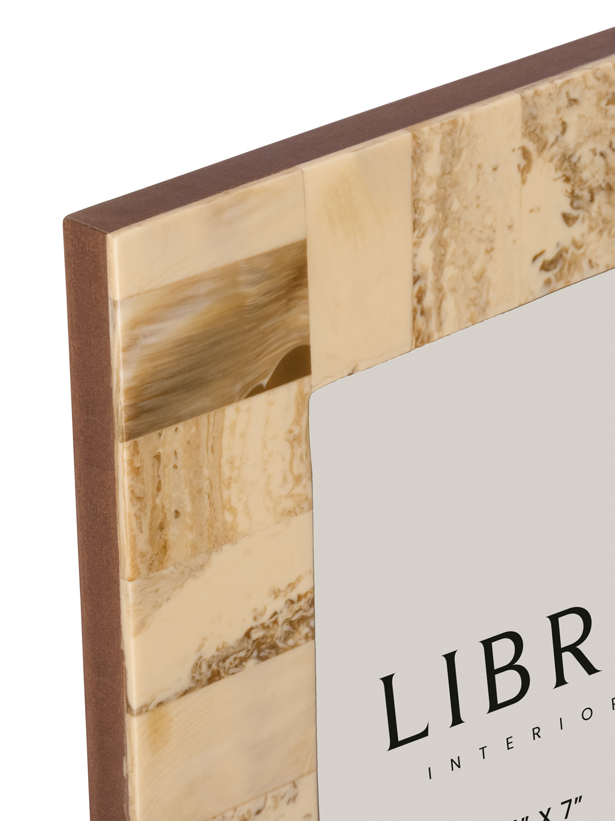 Close-up of the frame's upper left corner showing cream and beige resin sections with brown swirling patterns.