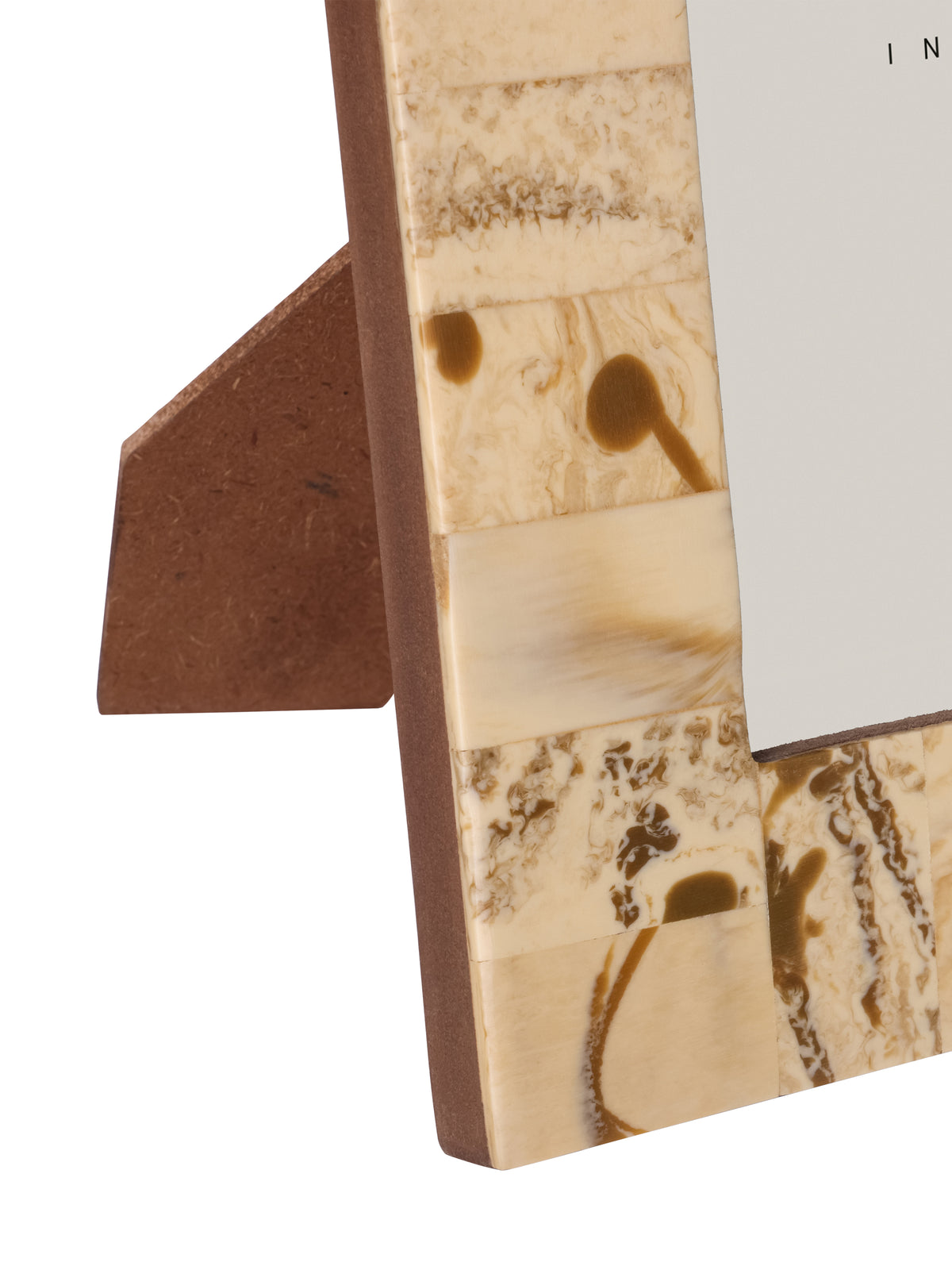 Detail of the lower left patchwork border, brown side edge and stand behind the photo frame.