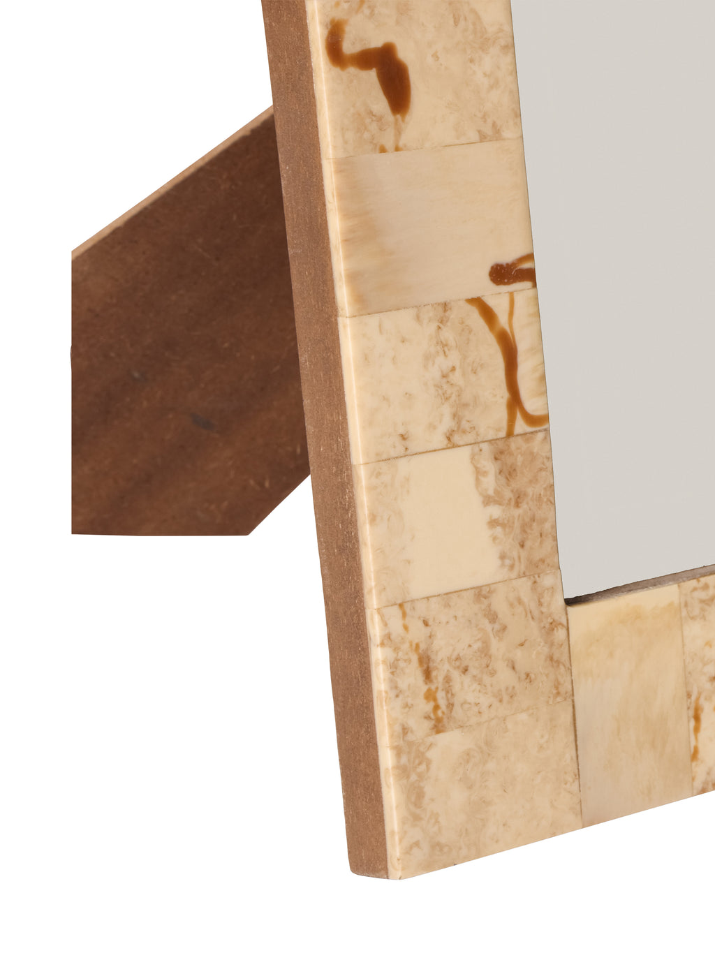 Detail of the lower left border with glossy cream and brown panels, the frame edge and easel behind.